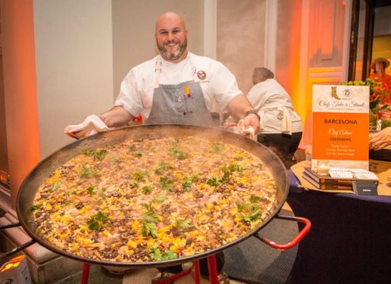 chef with big pan of paella