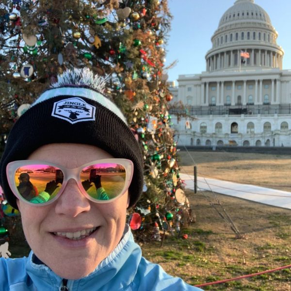 sarah with christmas tree and the capitol in the background